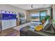 A cozy living room features an aquarium, a sectional, and sliding doors to the backyard at 5581 N 206Th Ave, Buckeye, AZ 85396