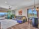 This living room features a comfortable sectional, an area rug, and access to the backyard at 5581 N 206Th Ave, Buckeye, AZ 85396