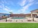 Beautiful backyard pool featuring a baja step, desert landscaping, and a secure safety fence at 5581 N 206Th Ave, Buckeye, AZ 85396