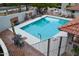 Community pool with lounge chairs, a BBQ, mature plants and a brick patio area at 6144 S Fairway Pl, Gold Canyon, AZ 85118