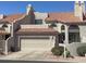 Beige two-story townhouse with a red tile roof and a two-car garage in a sunny landscape at 6144 S Fairway Pl, Gold Canyon, AZ 85118