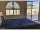 Serene bedroom featuring a sliding glass door to a private patio and decorative half round window at 6144 S Fairway Pl, Gold Canyon, AZ 85118