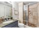 Bathroom with granite countertop vanity, tiled shower and elegant neutral decor at 6928 E 3Rd St, Scottsdale, AZ 85251