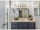 Bathroom featuring updated vanity with plants, an overhead light bar and a decorative mirror at 6928 E 3Rd St, Scottsdale, AZ 85251