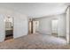 Spacious room featuring neutral carpet, large windows, a closet and an en suite bathroom at 6928 E 3Rd St, Scottsdale, AZ 85251