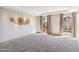 Bright, open living room featuring large windows and neutral carpeting creating a welcoming space at 6928 E 3Rd St, Scottsdale, AZ 85251