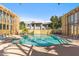 Relaxing community pool surrounded by lounge chairs and mature trees offering shade at 6928 E 3Rd St, Scottsdale, AZ 85251