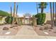 Inviting walkway leading to the gated courtyard with mature landscaping and tall palm trees at 6928 E 3Rd St, Scottsdale, AZ 85251