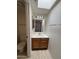 Bathroom with a single sink vanity, a large mirror with lighting and a toilet at 6945 E Cochise Rd # 108, Paradise Valley, AZ 85253