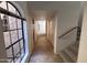 Inviting entryway with tiled floor and staircase leading to upper level and large front window at 6945 E Cochise Rd # 108, Paradise Valley, AZ 85253