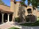 Well-manicured condo exterior with tiled roof, stucco walls, and landscaped yard at 6945 E Cochise Rd # 108, Paradise Valley, AZ 85253