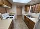 Efficient kitchen with neutral countertops and white appliances, offering a clean and practical space at 6945 E Cochise Rd # 108, Paradise Valley, AZ 85253