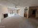 Bright living room featuring a fireplace, large windows, and modern ceiling fan at 6945 E Cochise Rd # 108, Paradise Valley, AZ 85253