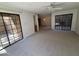 Spacious living area with patio access and neutral carpet throughout at 6945 E Cochise Rd # 108, Paradise Valley, AZ 85253