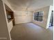 Cozy carpeted living room with dining area and outdoor access, ideal for entertaining at 6945 E Cochise Rd # 108, Paradise Valley, AZ 85253