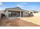 A spacious backyard featuring a covered patio and sliding glass doors that offer seamless indoor-outdoor living at 7433 W Buckhorn Trl, Peoria, AZ 85383