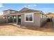 Exterior view of home featuring a covered patio and a spacious backyard at 7433 W Buckhorn Trl, Peoria, AZ 85383
