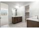Bathroom with double sinks, a mirror, and a walk-in closet at 7433 W Buckhorn Trl, Peoria, AZ 85383
