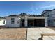 New home construction with exposed roof tile and lumber awaiting siding and finishing work at 7433 W Buckhorn Trl, Peoria, AZ 85383