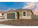 Charming one-story home featuring a gray exterior, manicured landscaping, and attached two-car garage at 7433 W Buckhorn Trl, Peoria, AZ 85383