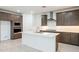 Well-equipped kitchen featuring a center island, stainless steel hood, and updated appliances at 7433 W Buckhorn Trl, Peoria, AZ 85383