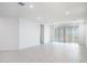Spacious and bright living room with white walls, tile flooring, and natural light at 7433 W Buckhorn Trl, Peoria, AZ 85383