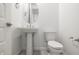 Elegant powder room featuring a pedestal sink, modern faucet, and stylish mirror at 7433 W Buckhorn Trl, Peoria, AZ 85383