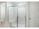 Bathroom featuring a glass-enclosed shower with a built-in seat at 7433 W Buckhorn Trl, Peoria, AZ 85383
