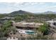 Aerial view of a desert property featuring a pool, patio, and mountain views at 8400 E Dixileta Dr # 153, Scottsdale, AZ 85266
