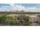 A scenic aerial view of a home surrounded by beautiful desert landscape and mountains at 8400 E Dixileta Dr # 153, Scottsdale, AZ 85266