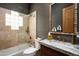 Bathroom with a textured wall, glass shower, and marble countertop and sink at 8400 E Dixileta Dr # 153, Scottsdale, AZ 85266