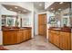 Bright bathroom featuring dual vanities, granite countertops, wood cabinets, and travertine flooring at 8400 E Dixileta Dr # 153, Scottsdale, AZ 85266