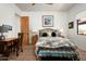 Cozy bedroom featuring a wooden desk, stylish bedding, and bright natural light from the window at 8400 E Dixileta Dr # 153, Scottsdale, AZ 85266