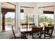 Elegant dining room with wood table set, view of desert landscape, and modern lighting at 8400 E Dixileta Dr # 153, Scottsdale, AZ 85266
