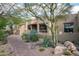 Front exterior featuring desert landscaping and a charming brick walkway at 8400 E Dixileta Dr # 153, Scottsdale, AZ 85266