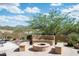 Cozy outdoor area with built-in seating surrounding a stone fire pit at 8400 E Dixileta Dr # 153, Scottsdale, AZ 85266
