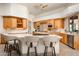 Modern kitchen with light wood cabinets, stainless steel appliances, and a marble countertop island at 8400 E Dixileta Dr # 153, Scottsdale, AZ 85266