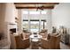 Bright living room with fireplace, wood beam ceiling, and views of the outdoor pool and desert landscape at 8400 E Dixileta Dr # 153, Scottsdale, AZ 85266