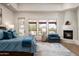 Serene main bedroom with a fireplace, desert views, and access to the outdoor patio at 8400 E Dixileta Dr # 153, Scottsdale, AZ 85266