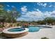 Beautiful pool and spa area with rock features and lush landscaping, creating a private oasis at 8400 E Dixileta Dr # 153, Scottsdale, AZ 85266