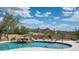 Stunning pool with a waterfall feature and views of the surrounding desert landscape at 8400 E Dixileta Dr # 153, Scottsdale, AZ 85266