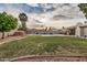 Backyard oasis featuring a pool, expansive lawn, mature trees and an outdoor living space at 863 W Kiva Ave, Mesa, AZ 85210