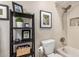 Bathroom features shelves with decor, framed artwork, and shower/tub combination at 863 W Kiva Ave, Mesa, AZ 85210