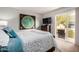 Bedroom with comfortable bed, large art piece, and sliding doors to the outside patio at 863 W Kiva Ave, Mesa, AZ 85210