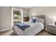 Cozy bedroom featuring a comfortable bed, wood headboard, and a sunlit window with neighborhood views at 863 W Kiva Ave, Mesa, AZ 85210