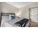 Comfortable bedroom with a decorative bedspread, throw blanket and a large window for natural light at 863 W Kiva Ave, Mesa, AZ 85210