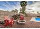 Cozy backyard with a firepit, woodpile, and adirondack chairs for outdoor enjoyment at 863 W Kiva Ave, Mesa, AZ 85210