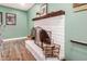 Charming, painted fireplace with mantel, decorative accessories, and wood flooring at 863 W Kiva Ave, Mesa, AZ 85210