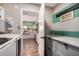 Pass-through Laundry room with white cabinets, countertops and views into a bright kitchen at 863 W Kiva Ave, Mesa, AZ 85210