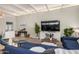 Cozy living room with neutral tones, comfortable seating, and a large television at 863 W Kiva Ave, Mesa, AZ 85210